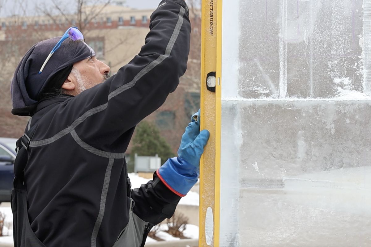 Ice sculptor Dean DeMarias works on a block of ice at Freezefest 2025 Thursday.