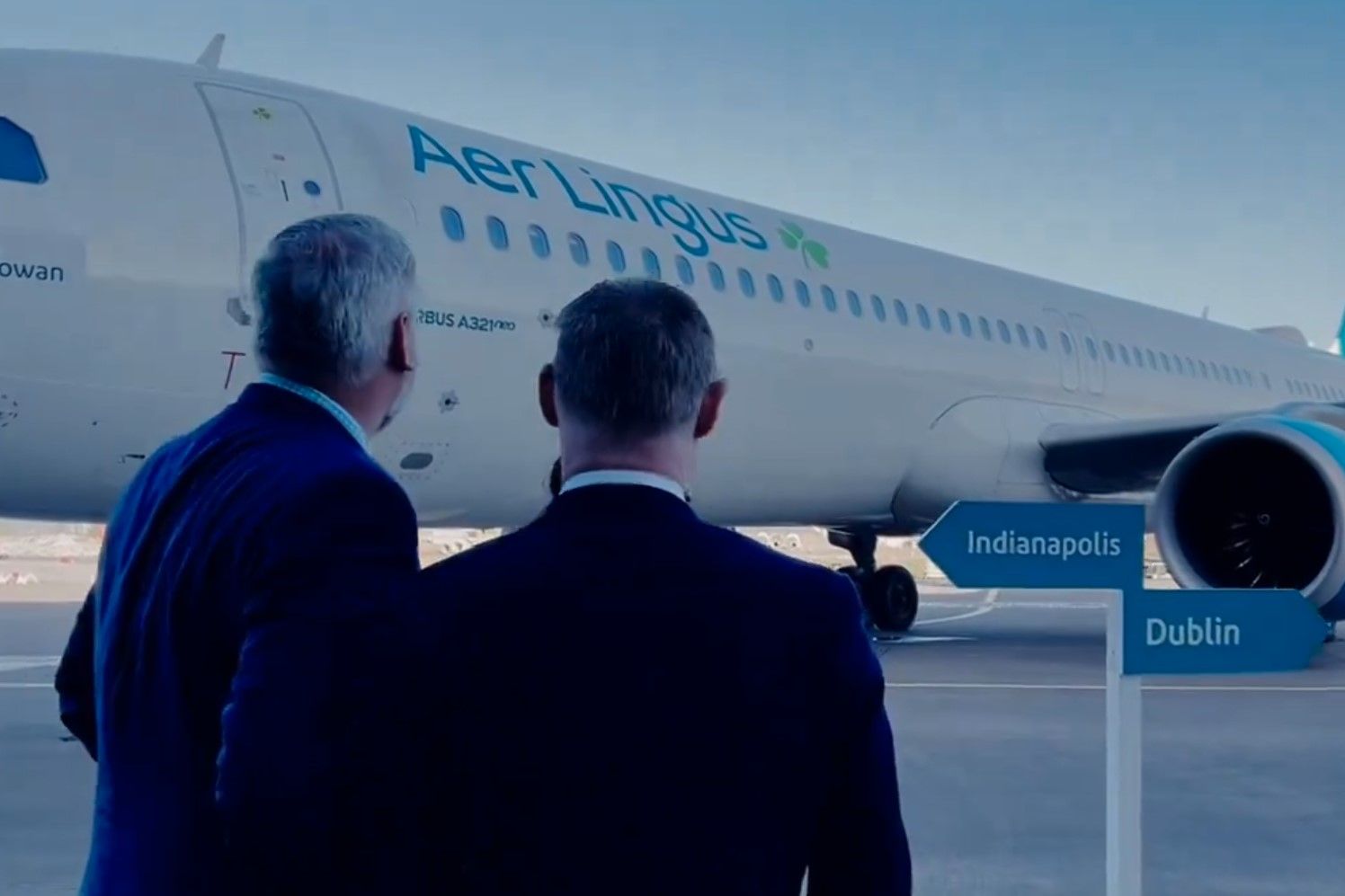 Indiana Gov. Eric Holcomb, left, and several others admire an Aer Lingus plane.