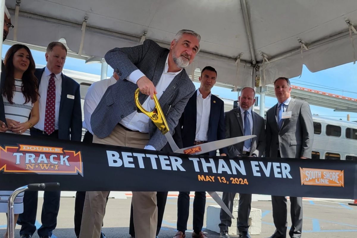 Governor Eric Holcomb cuts the ribbon on the South Shore Line's Double Track project at the railroad's Miller station on May 13.