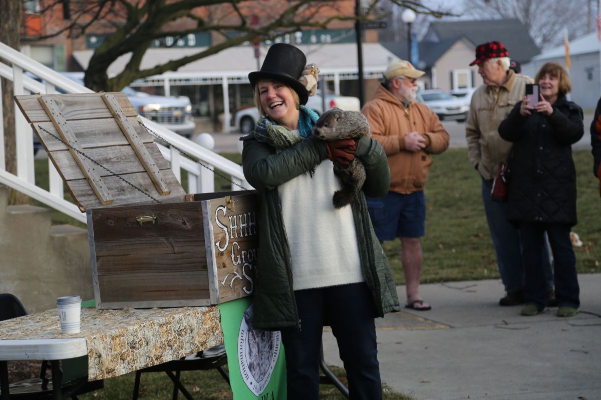 Volunteers at the Hope, Indiana Groundhog Day ceremony hold up Hope the groundhog.