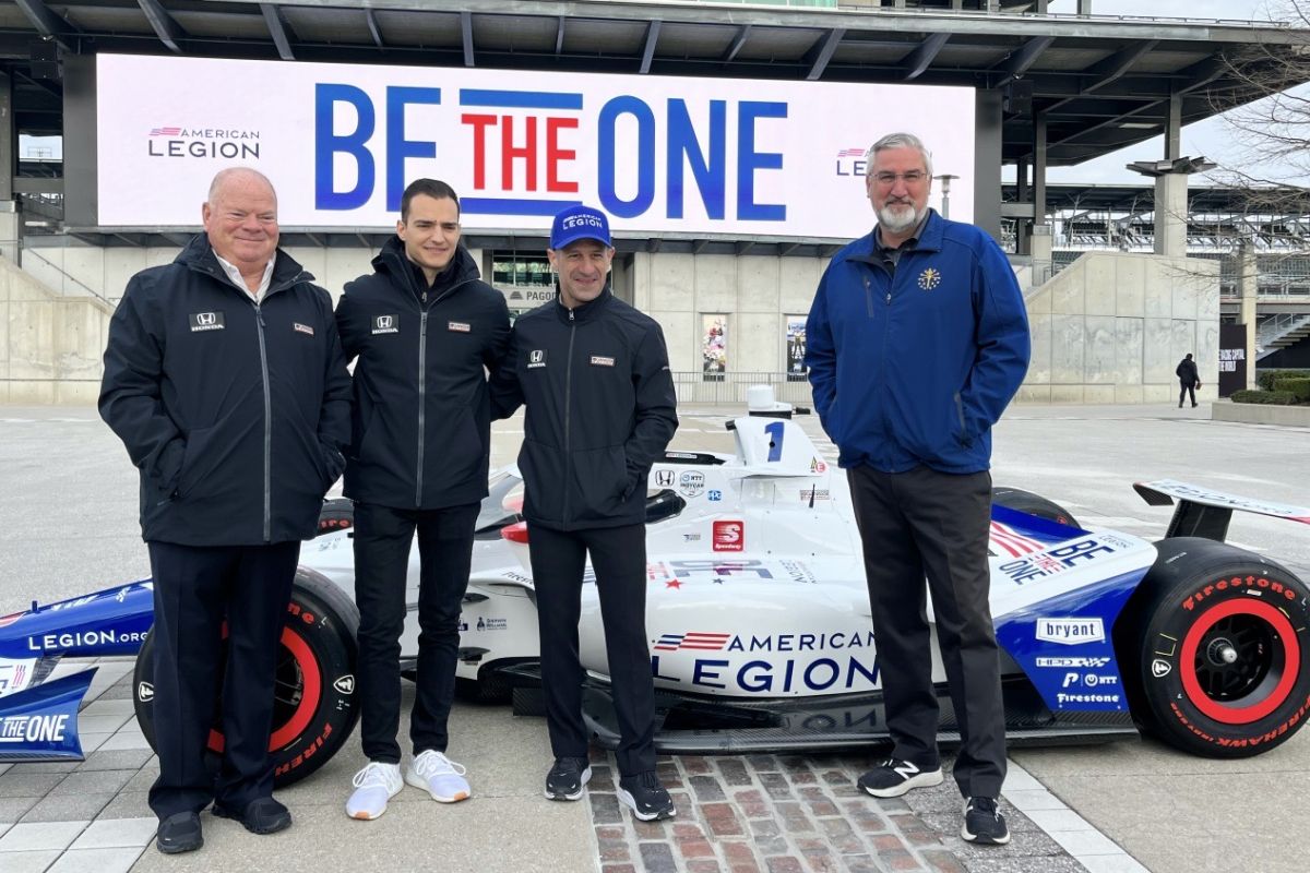 Gov. Eric Holcomb (right) stands next to Tony Kanaan, 2013 Indy 500 race winner and Chip Ganassi (left), owner of Chip Ganassi Racing.