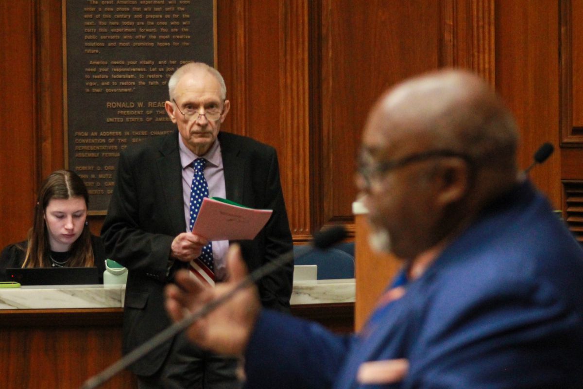 Rep. Jeff Thompson (R-Lizton), background, watches Rep. Greg Porter (D-Indianapolis), foreground, presents one of the House Democrats' amendments to the state budget bill on Feb. 19, 2025.