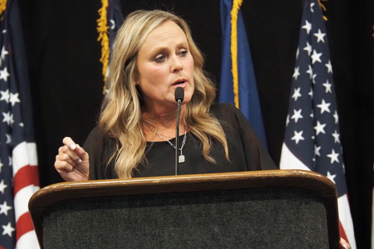 Jennifer McCormick speaking into a microphone at a podium