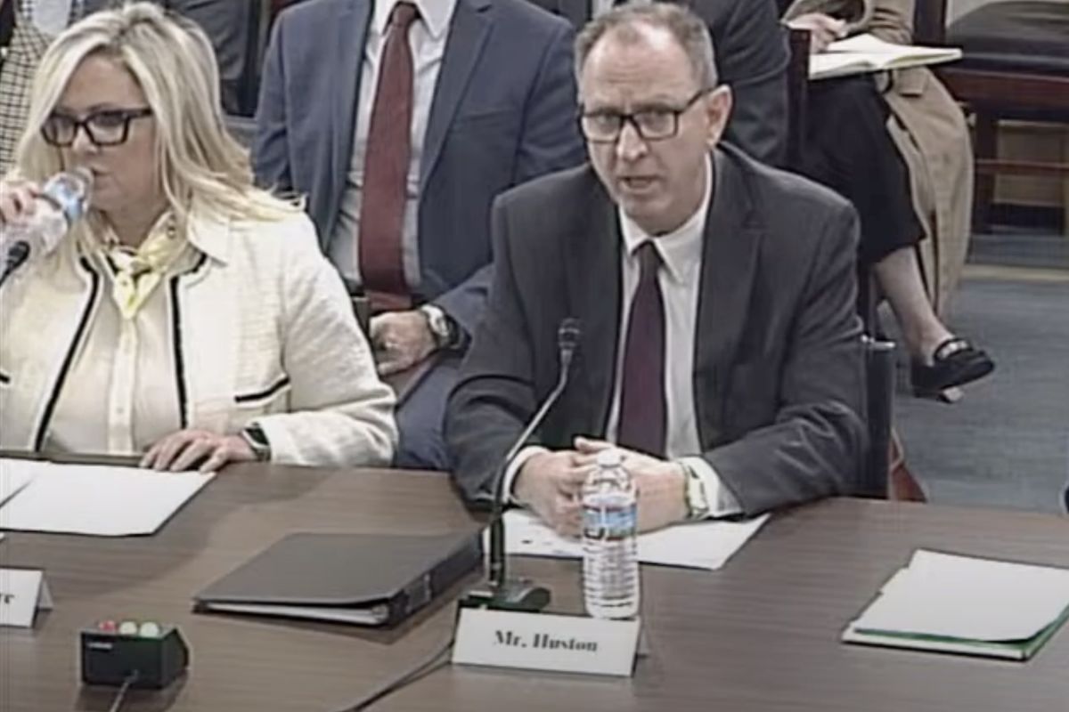 IURC Chairman Jim Huston speaks at a U.S. House Committee on Energy and Commerce hearing on the challenges state utility regulators face in delivering reliable and affordable energy. He is a White man, wearing glasses and a suit.