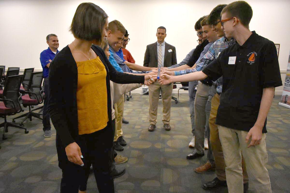 Youth apprentices with CareerWise Elkhart County participate in a team-building activity while Jason Harrison of Horizon Education Alliance supervises.