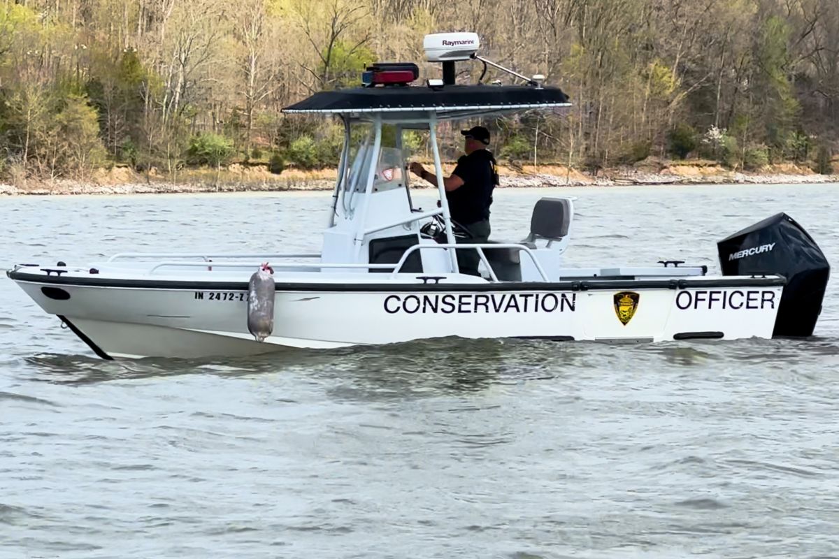 A conservation officer participates in the search for a pair of missing IU students at Lake Monroe Saturday.y.