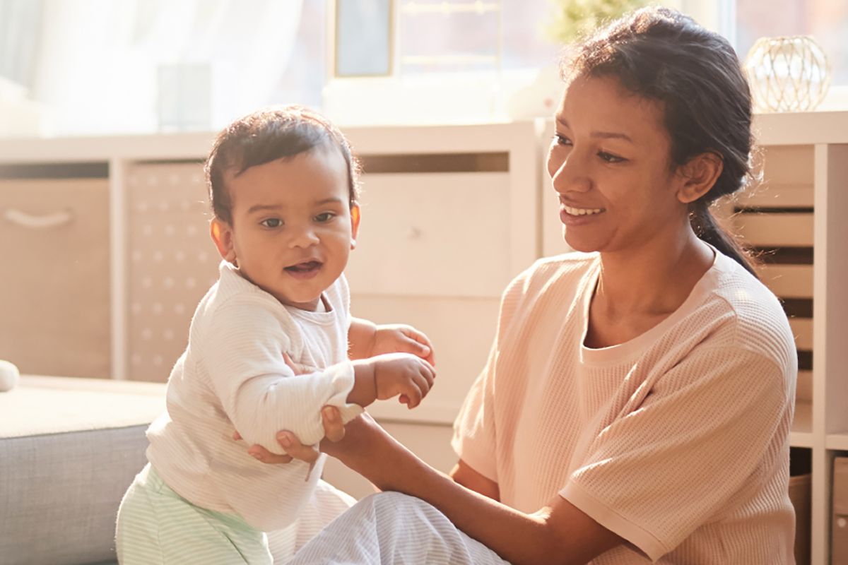 A woman holds her baby. 