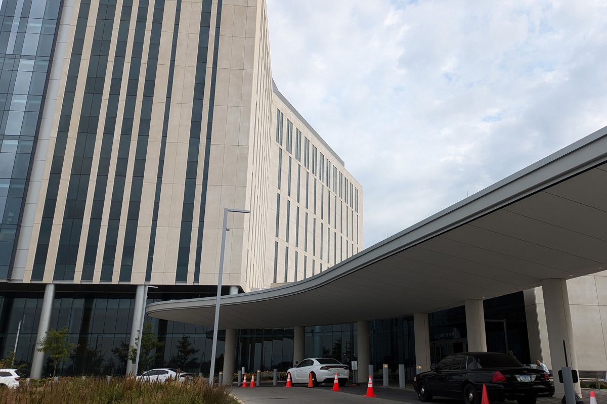 The exterior of the Marion County Justice Campus. A large limestone building stands over a carport.