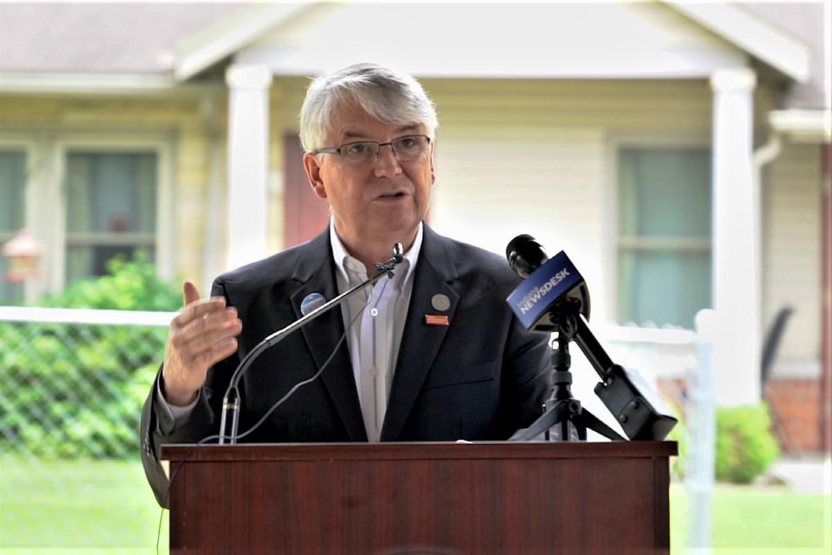 A photo of Mayor John Hamilton speaking at a press conference on housing insecurity.