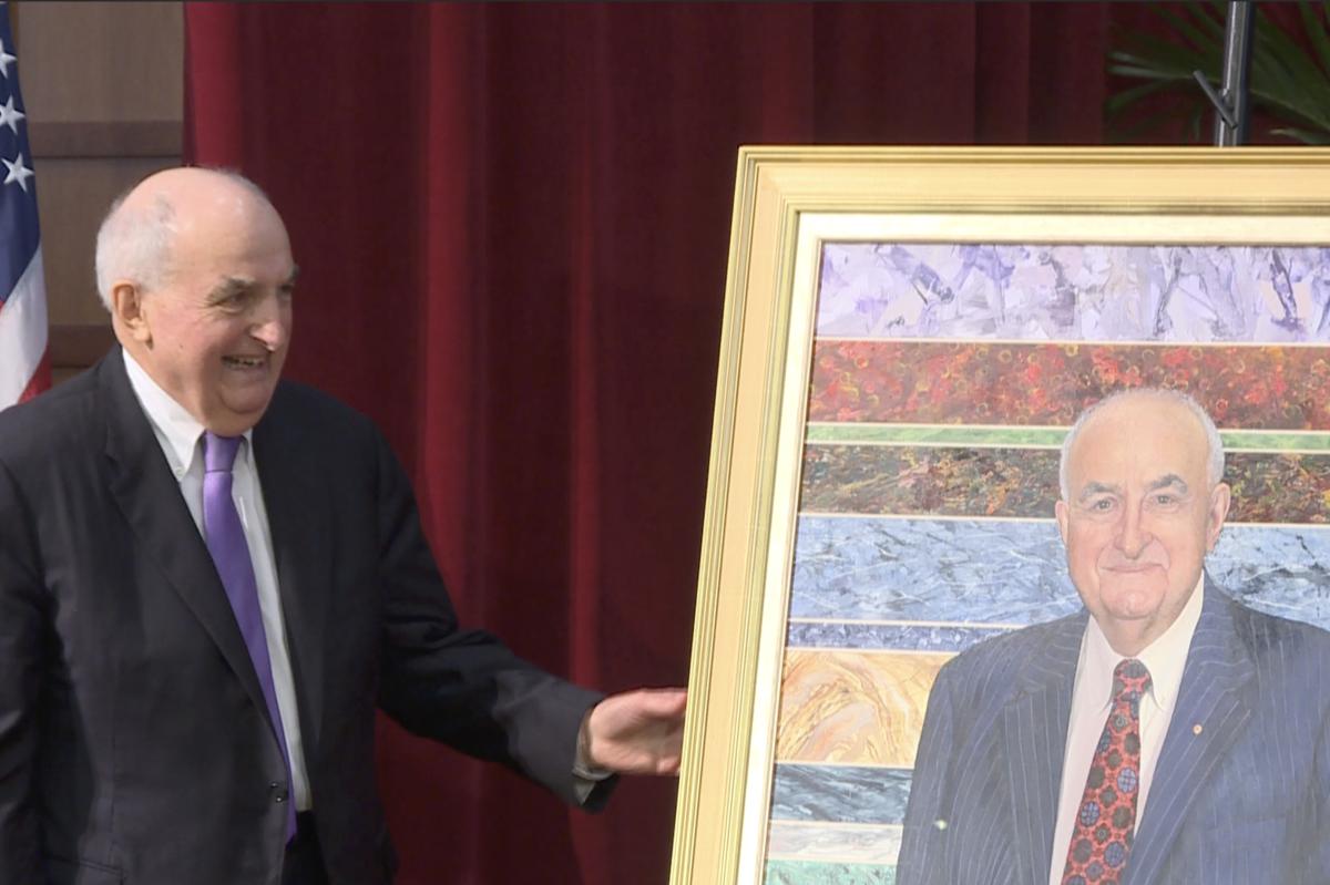 Former IU president Michael McRobbie poses with his official portrait Friday at Franklin Hall.