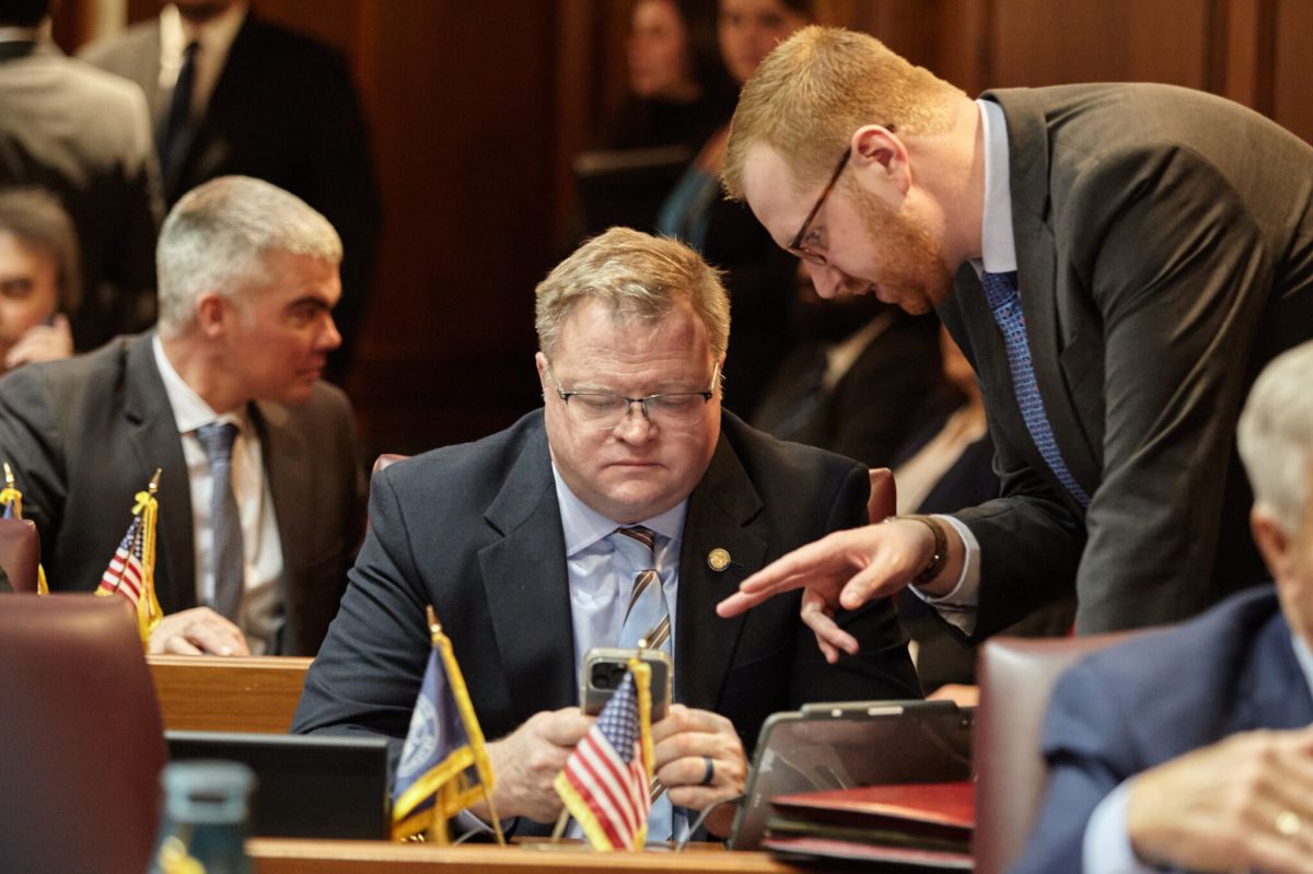  Rep. Mike Speedy, R-Indianapolis, checks his phone on the House floor.