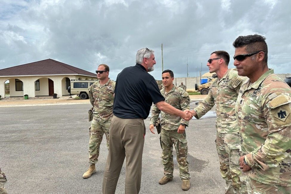 Gov. Eric Holcomb greets military members on Nov. 15, 2023, while visiting Hoosier national guard soldiers in Kenya.