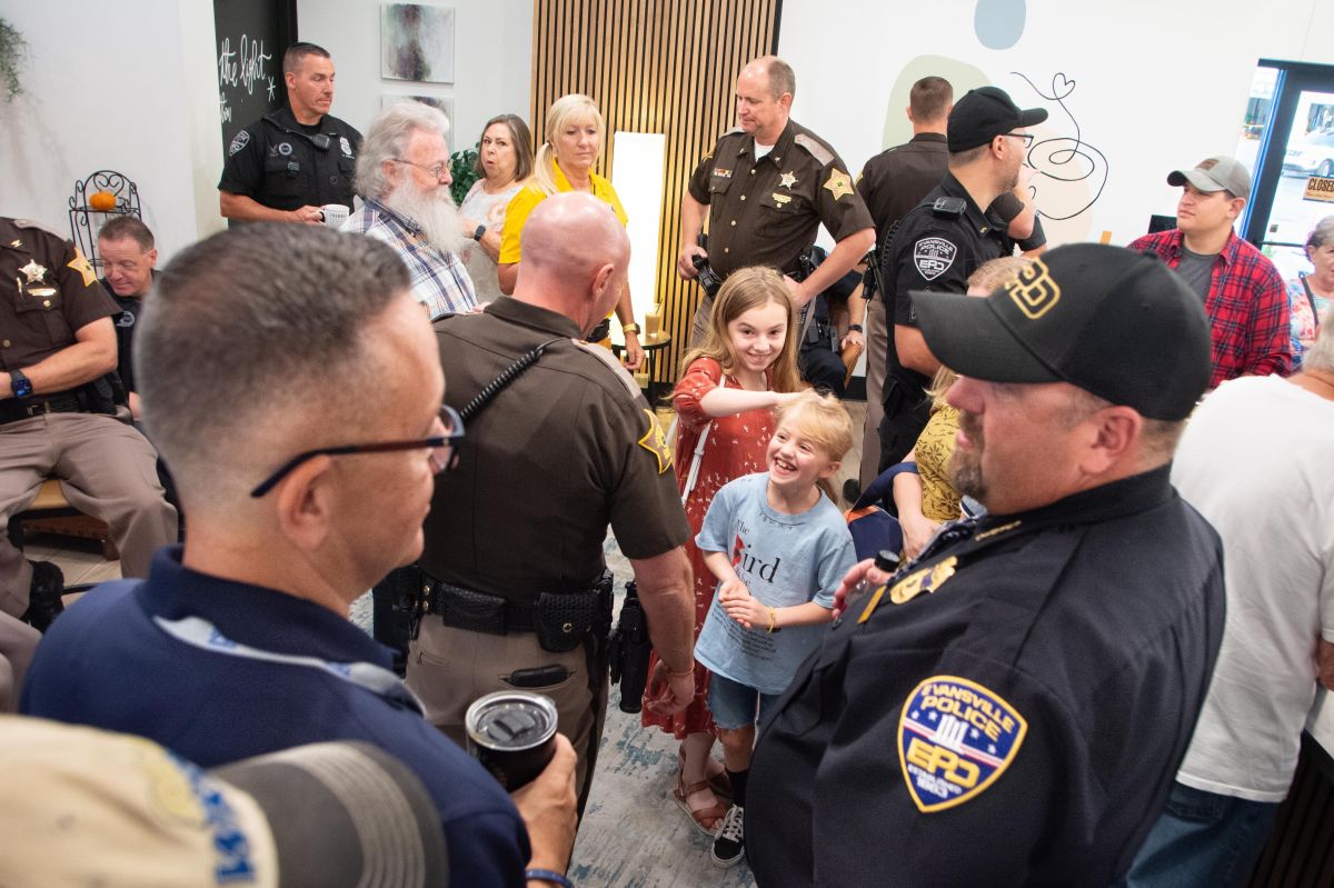 Vanderburgh County Sheriff’s Deputy Mark Rasure is speaking with Ashley Brendel’s children — Gabbie, 12 and Cadence 7, at the national Coffee with a Cop Day in early October. 