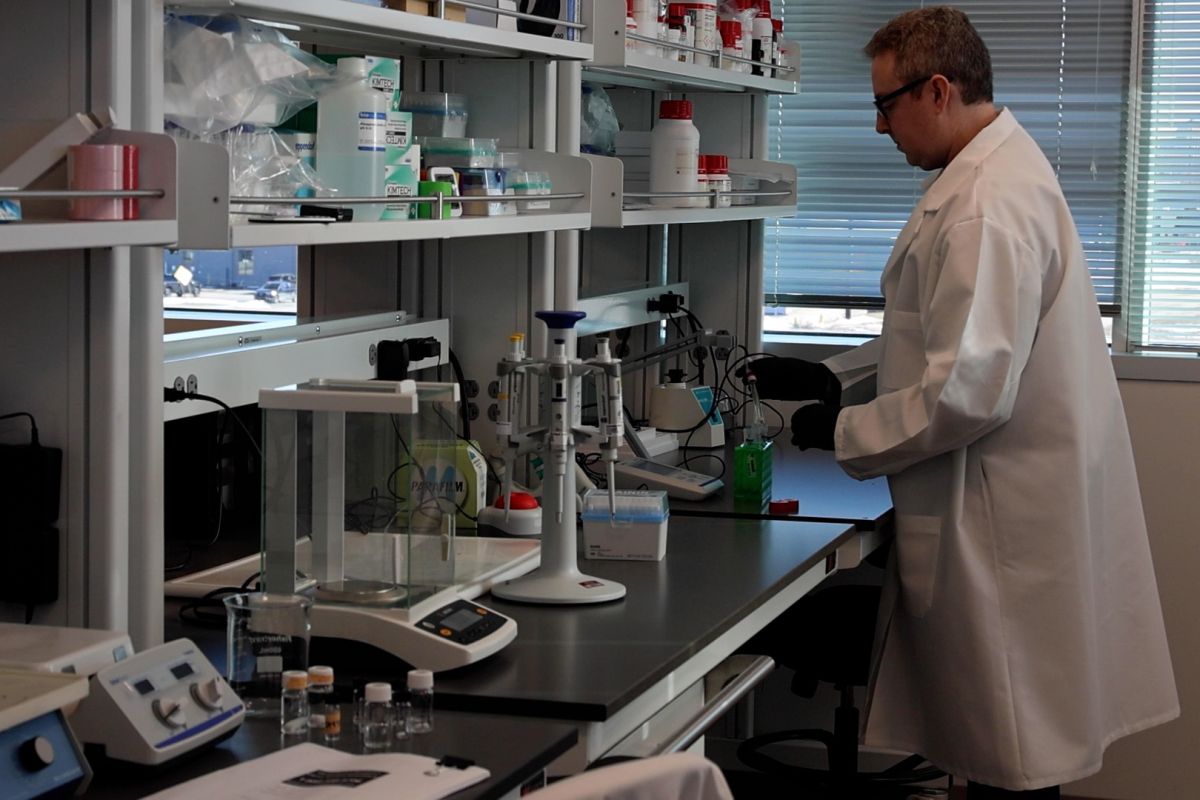 A Indiana University researcher works in a labb.