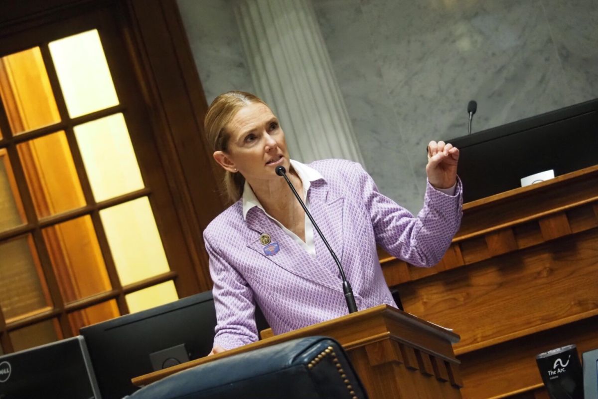 Sen. Shelli Yoder speaking into a microphone at a podium