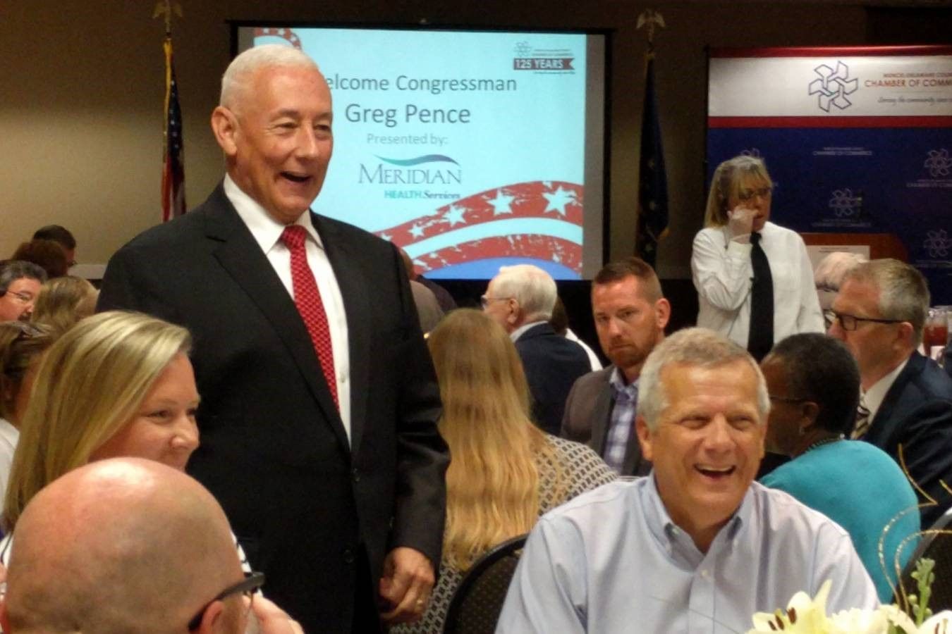 U.S. Rep. Greg Pence (R-6th District), standing, talks with constituents at a Chamber of Commerce lunch in Muncie in August 2019