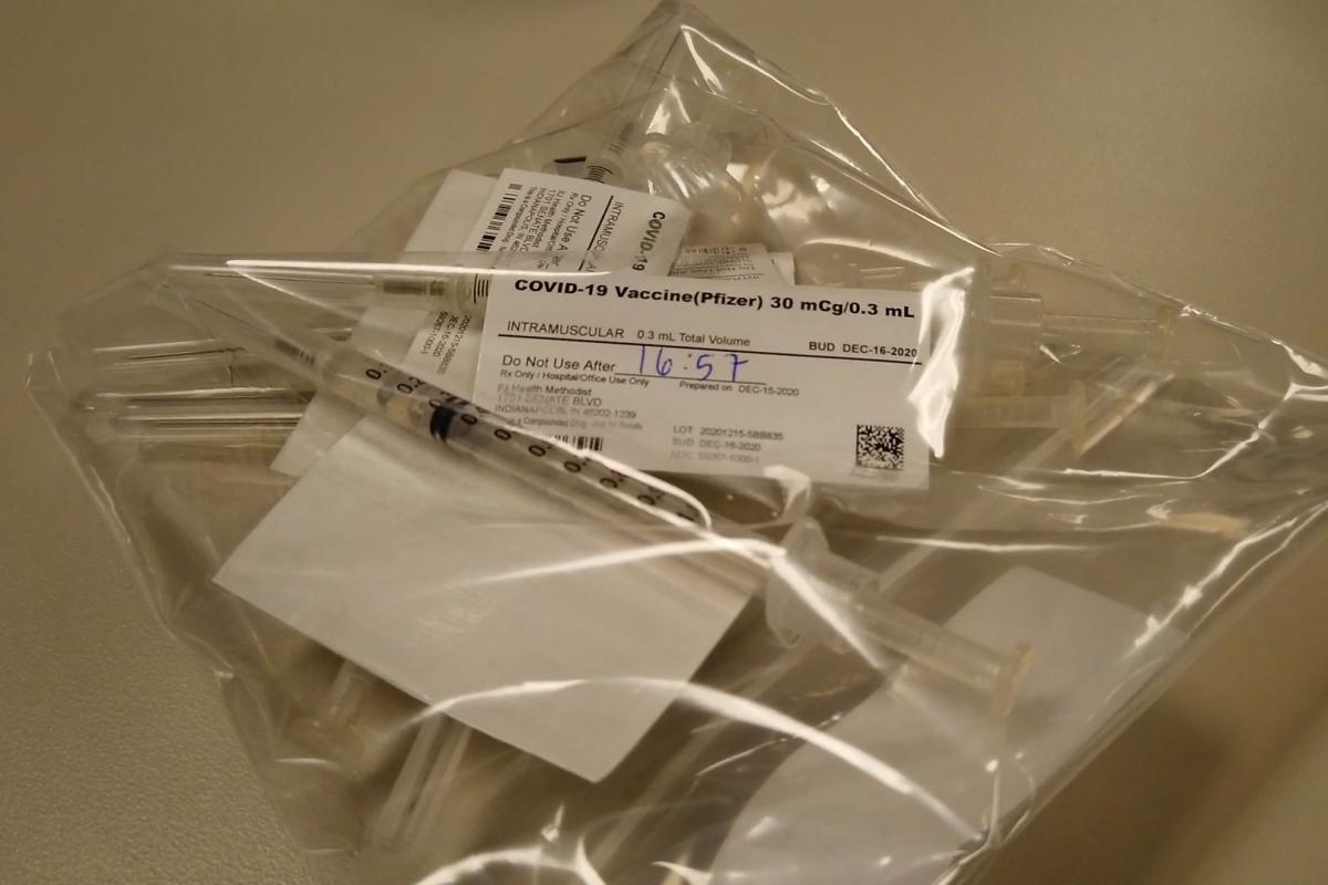 Doses of the COVID-19 vaccine are readied for use.