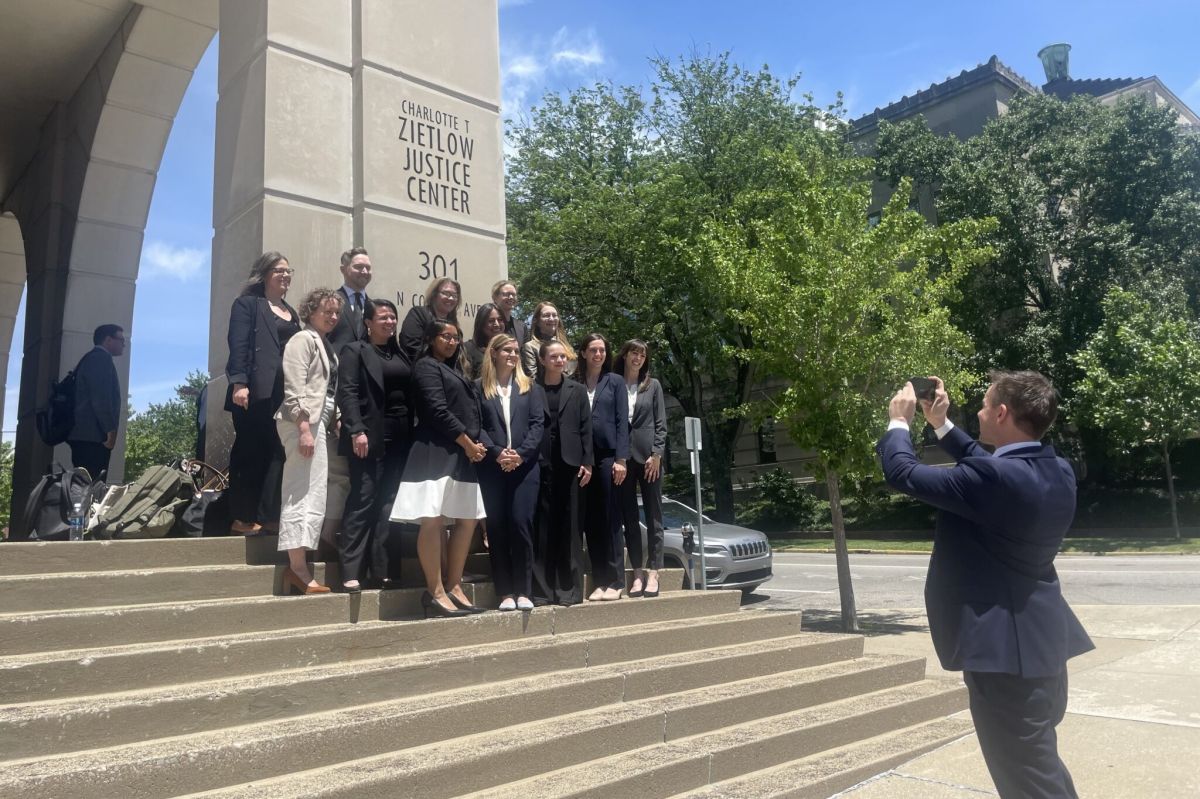 At their request, Indiana Solicitor General James Barta — who defended the state’s abortion ban — takes a photo of plaintiffs in the case Friday May 31 outside the Monroe County Courthouse.