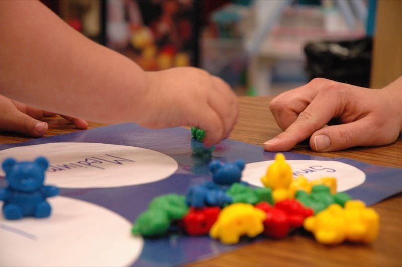 preschool children play with rainbow counting bear toys