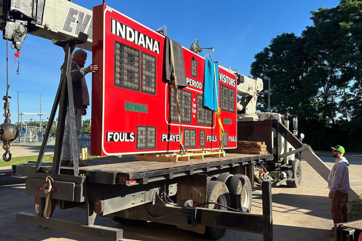 Workers load an old IU scoreboard for transportation to The Upstair's Pub.