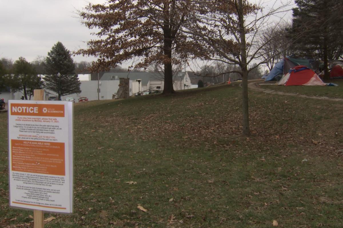 A photo of Bloomington's Seminary Park and a sign that says people must vacate.