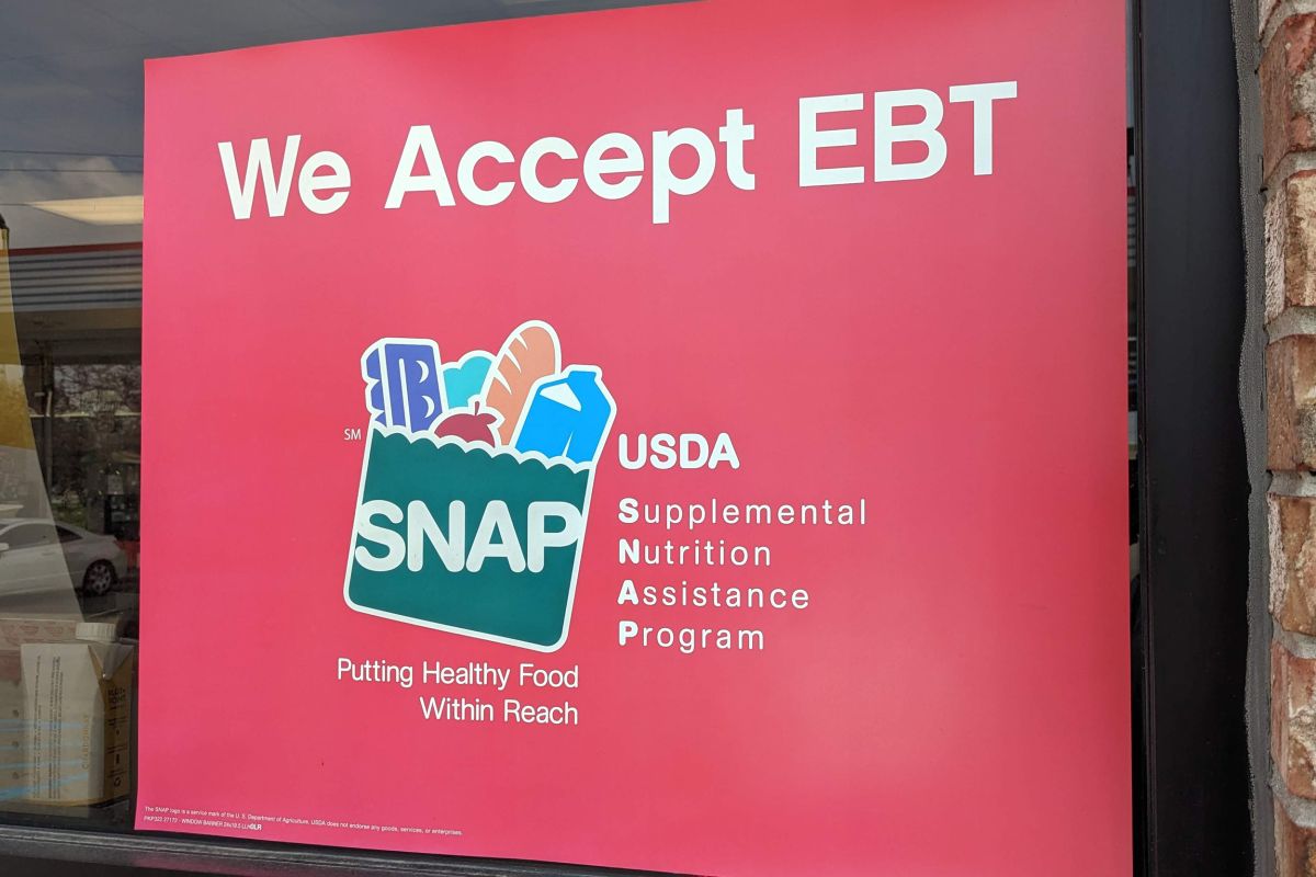 A red sign that says "We Accept EBT" in white letters.