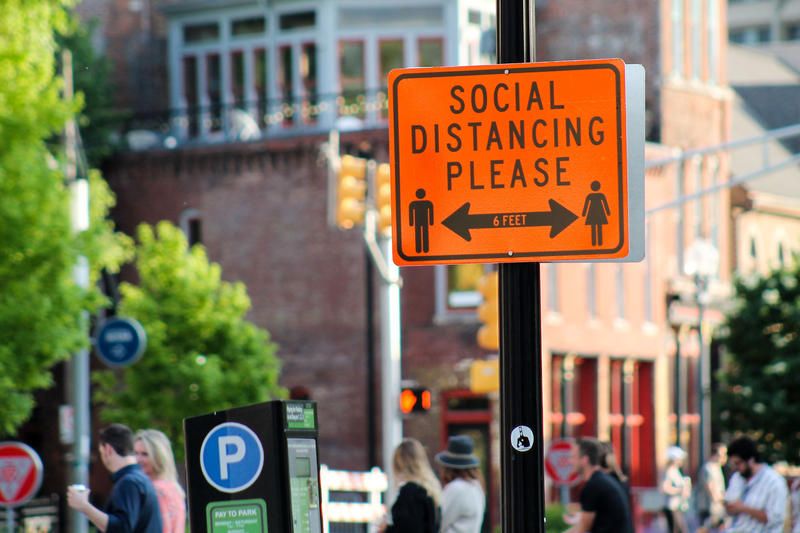 Downtown Indianapolis blocked parts of Mass Ave. to allow outdoor seating. The city also installed signs, reminding people to social distance while visiting businesses and restaurants.