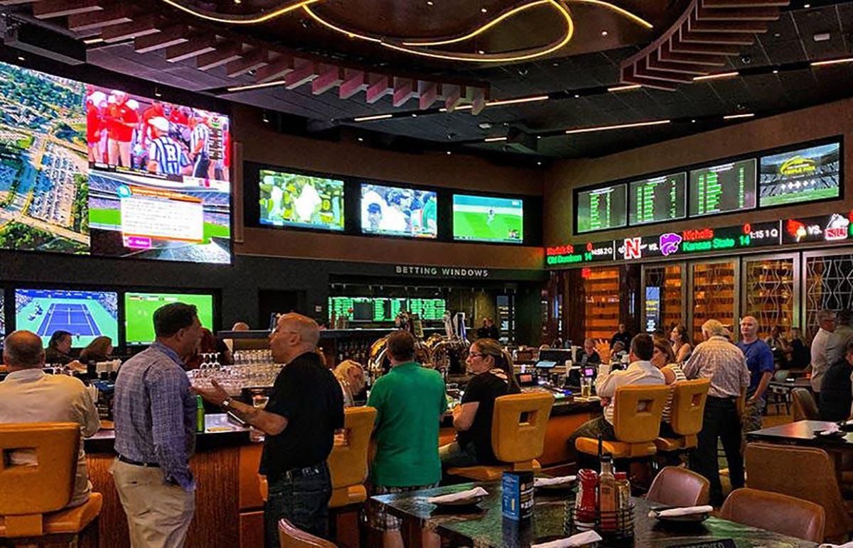 A generic photo of people at a casino (gambling, betting, sports betting)