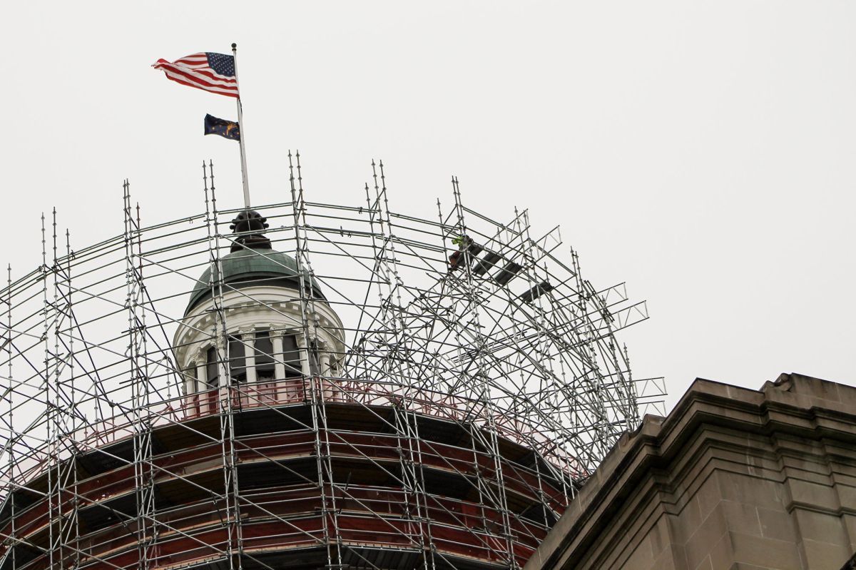 The Statehouse dome is surrounded by scaffolding.