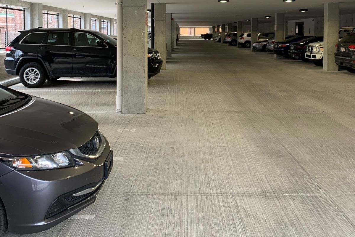 A photo of a parking garage on the ground floor of a student housing complex.f