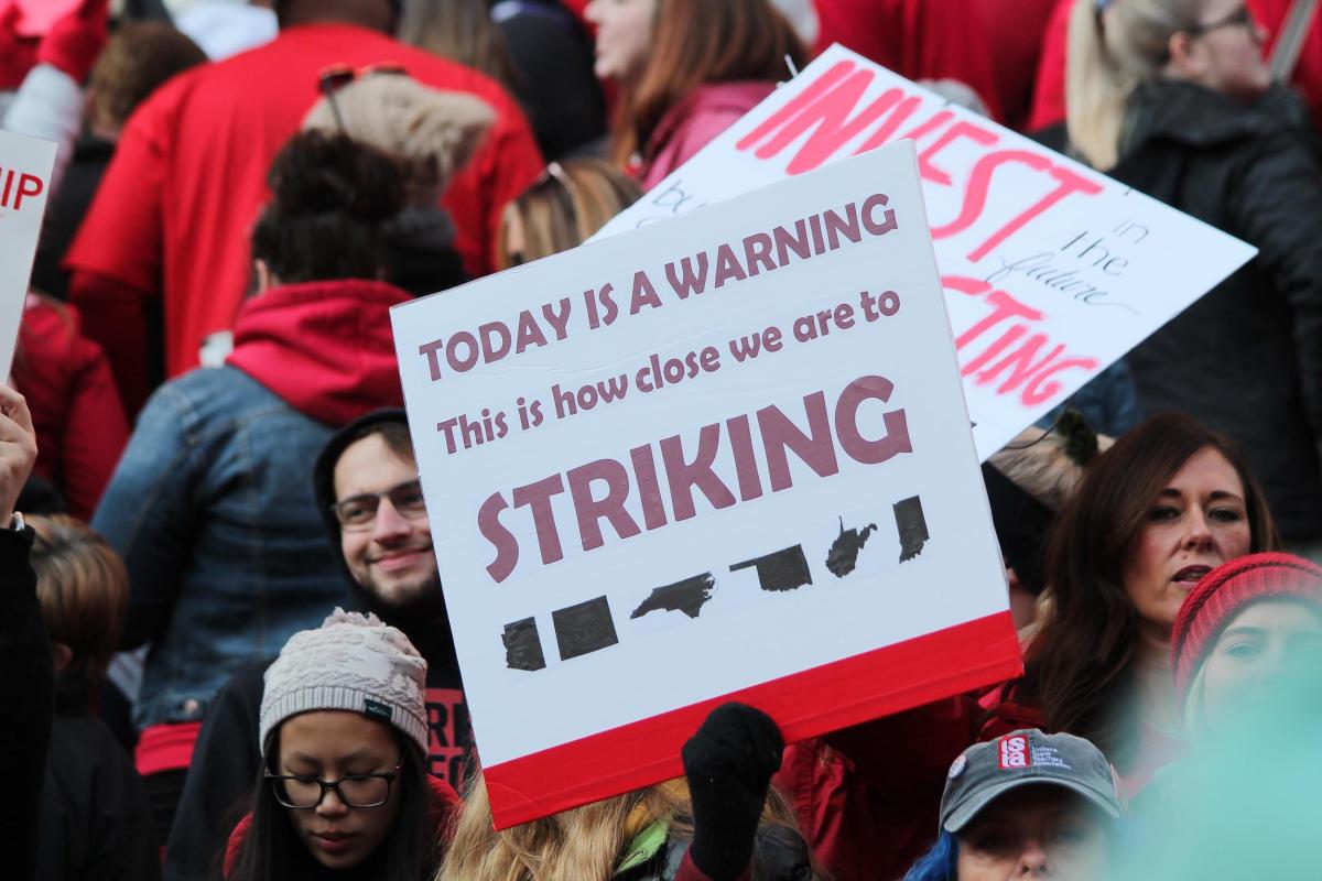Many of the teachers at Nov. 2019's Red For Ed rally held signs, including this one, referencing recent teacher strikes across the country.