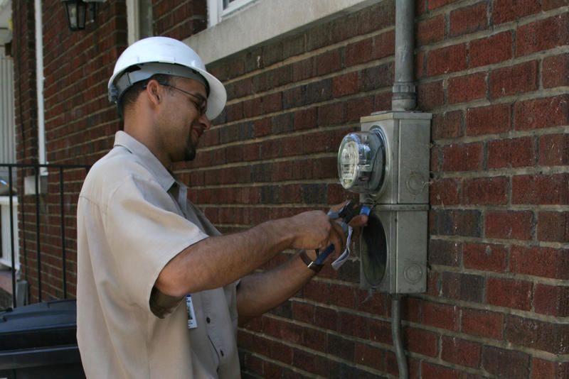 A Duke Energy technician disconnecting electricity at a residence due to nonpayment in North Carolina, 2008.