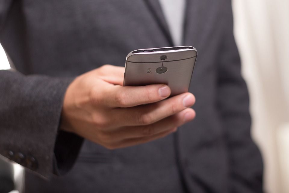 A stock image of a man holding a cell phone/telephone.