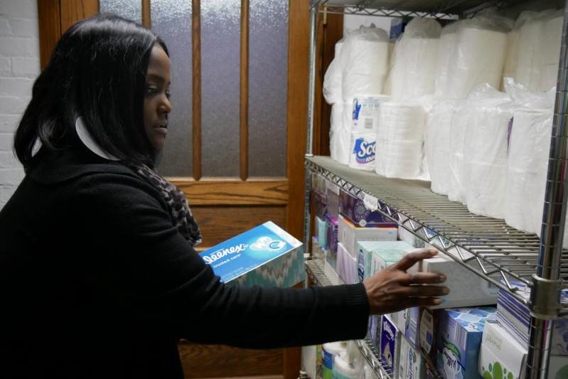 Jacqueline Willet of Coburn Place looking at supplies they use to stock up transitional housing units that survivors move into with their children.