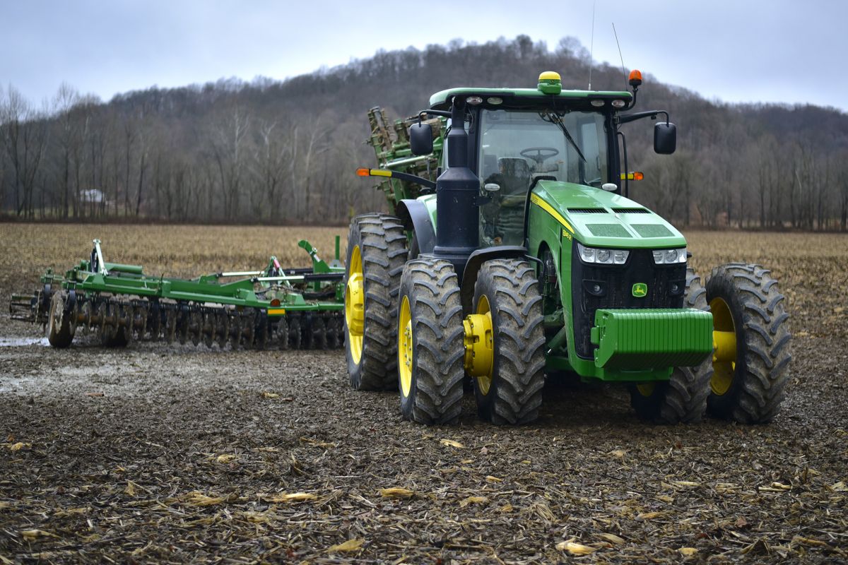 A tractor drives through a field.