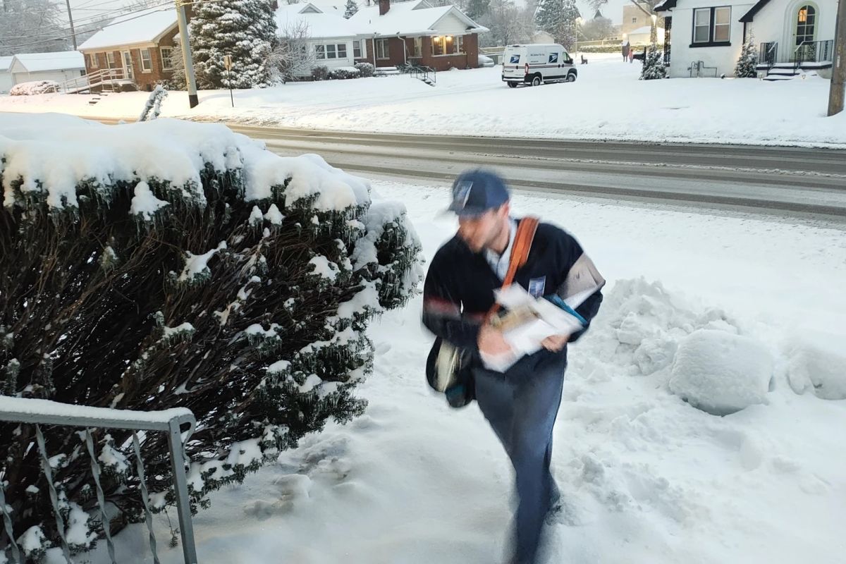 USPS Letter Carrier Stephen Sing makes his way across the ice encrusted sidewalks of Bellemeade Avenue in Evansville in early January.