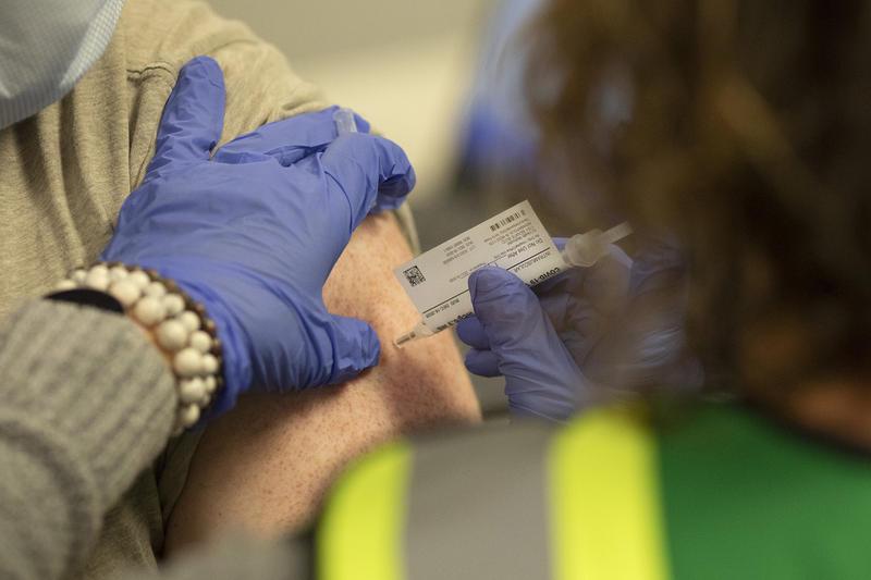 A person receives a dose of the Pfizer covid-19 vaccine.