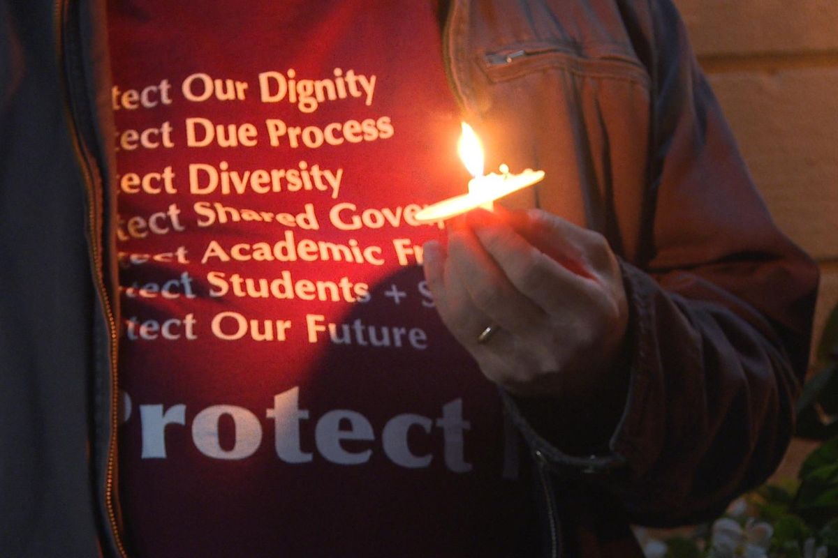 a close-up of a hand holding a candle