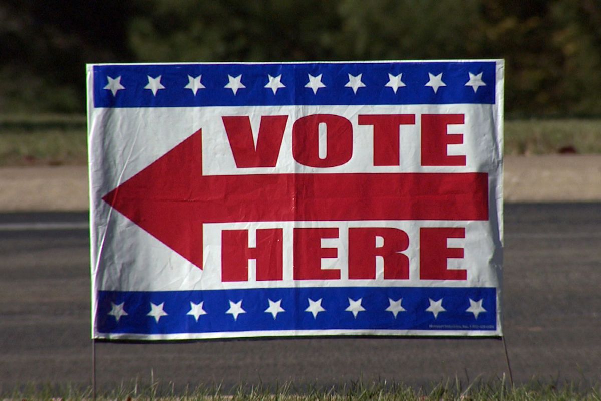A voting sign in a yard