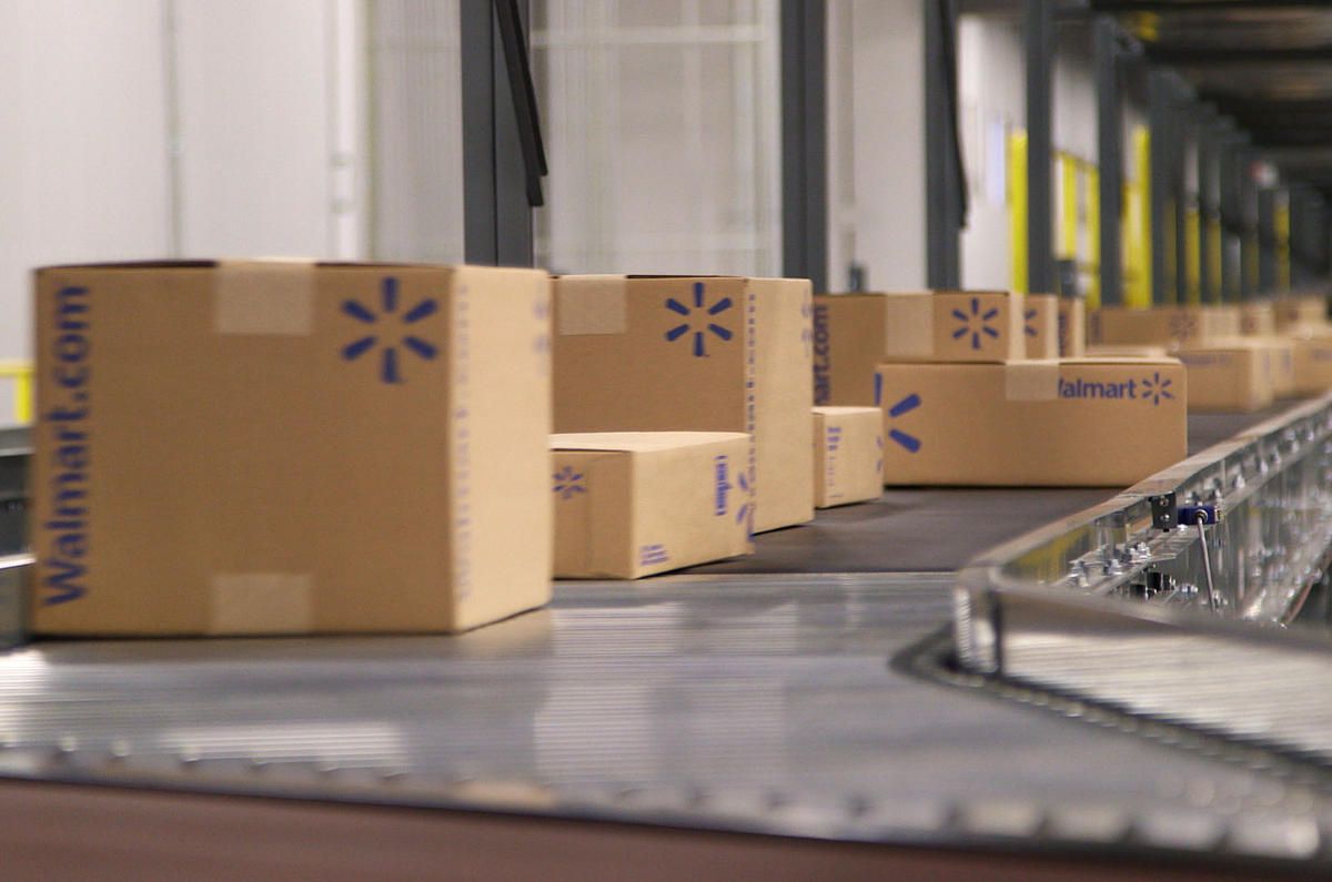 Walmart e-commerce fulfillment center boxes being shipped.