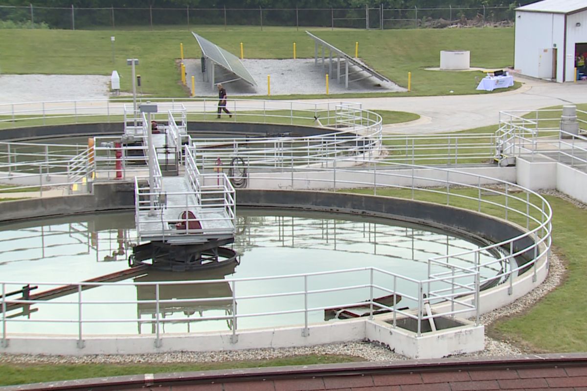 A large pool of water, called a lagoon, at the Shelbyville Wastewater Treatment Plant. There is a metal railing around the perimeter of the pool and a platform walkway that allows access to the center of the lagoon.