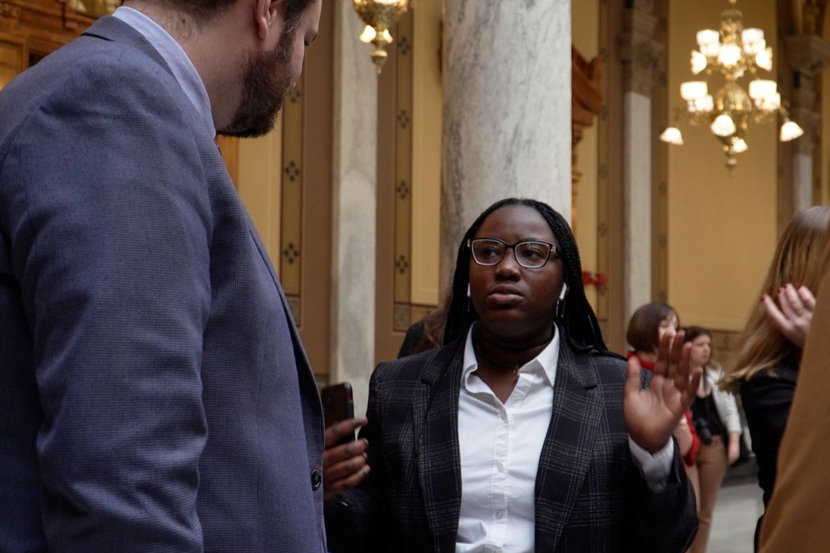 A member of the youth climate action group Confront the Climate Crisis talking to Sen. J.D. Ford (D-Indianapolis) at the climate rally at the Indiana Statehouse.
