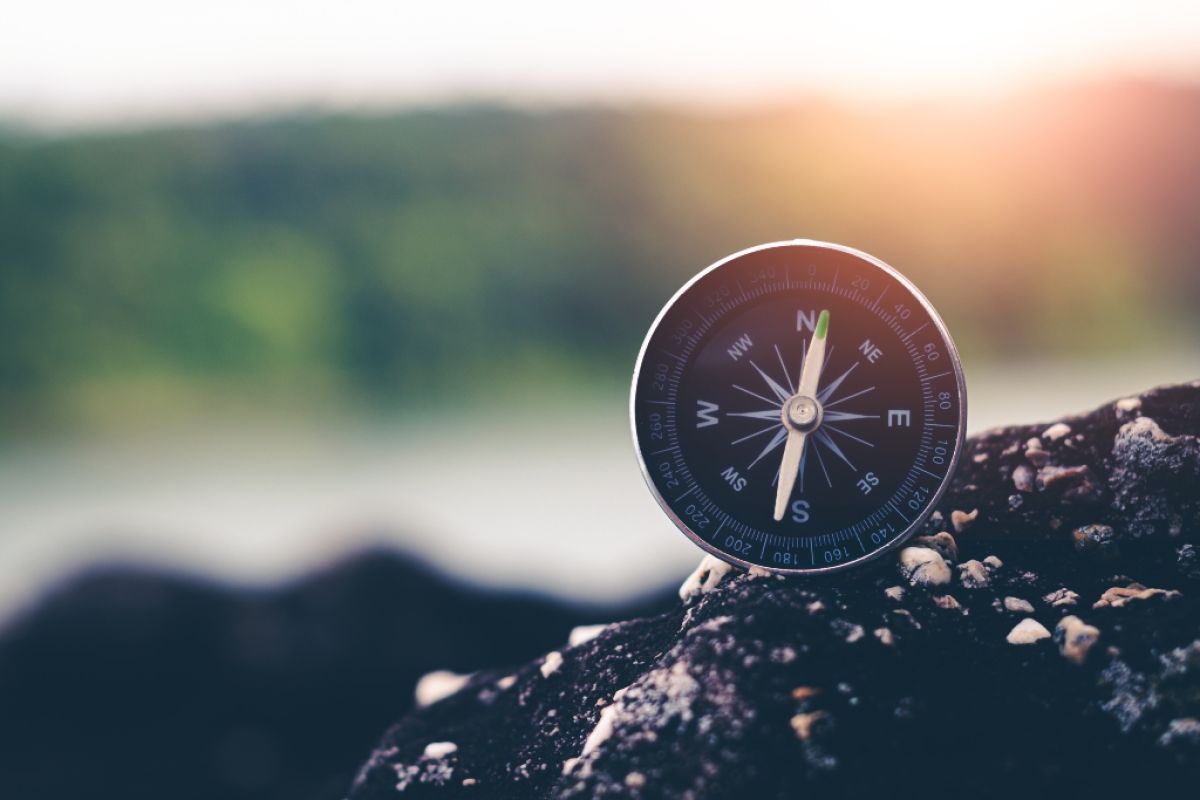 Compass sitting on rock.
