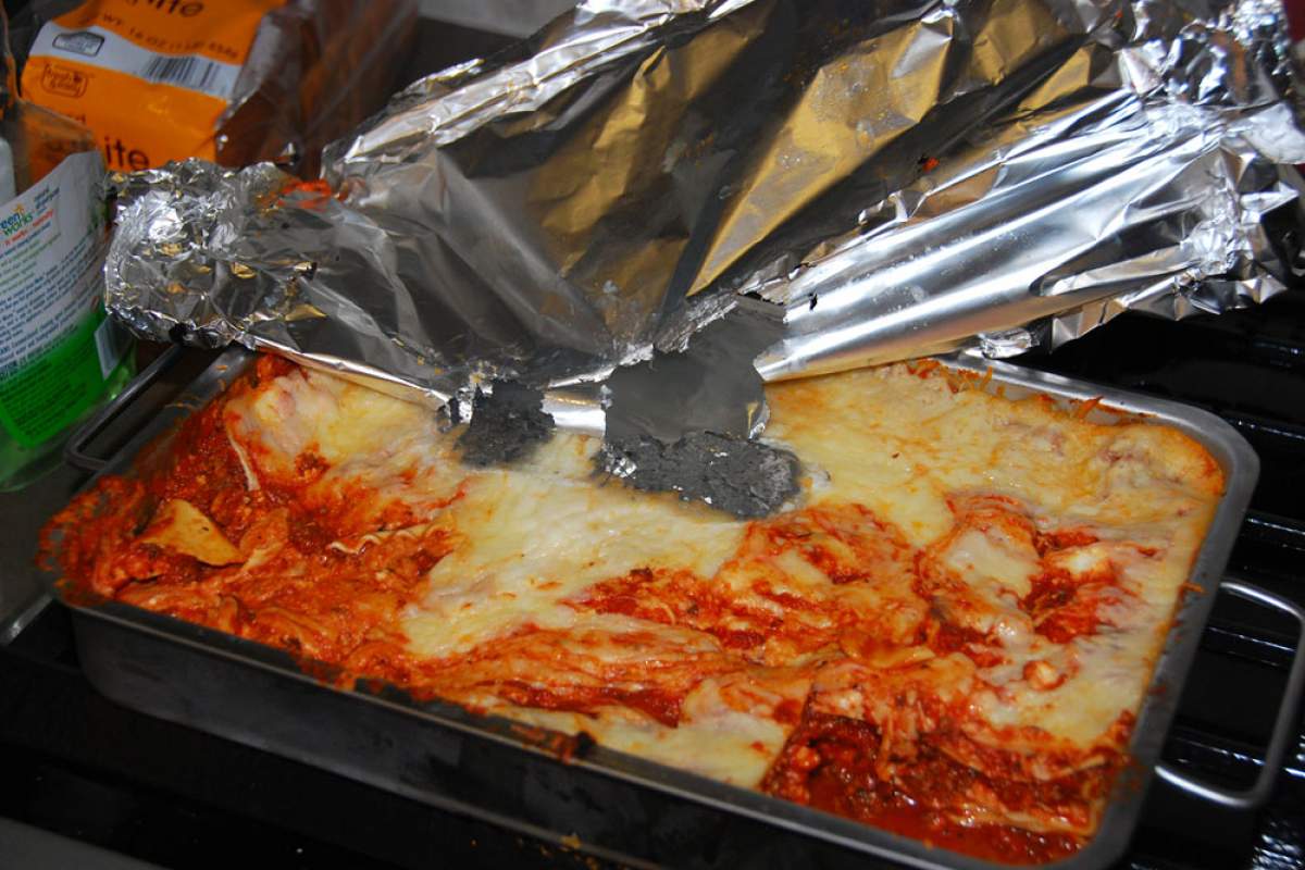 a pan of leftover lasagna ate a hole in aluminum foil