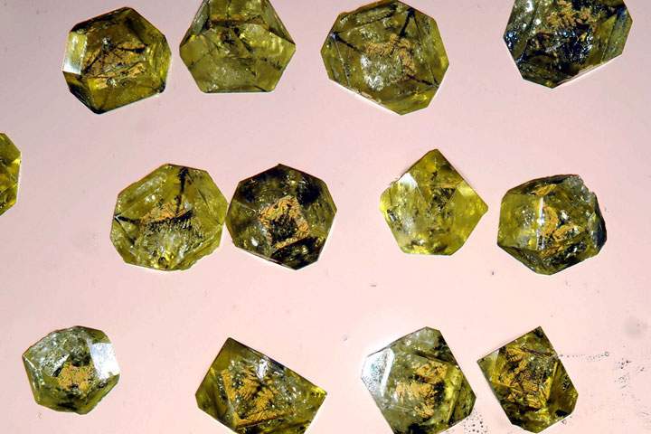 green synthetic diamonds on a pink background