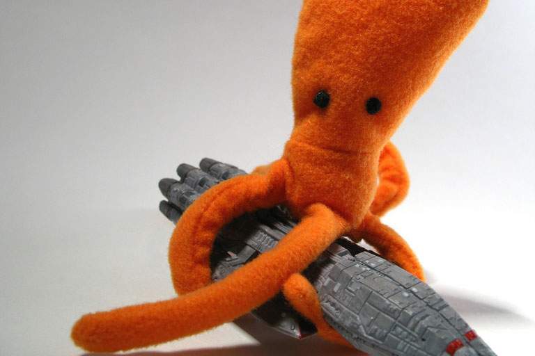 octopus stuffed animal holding a ship