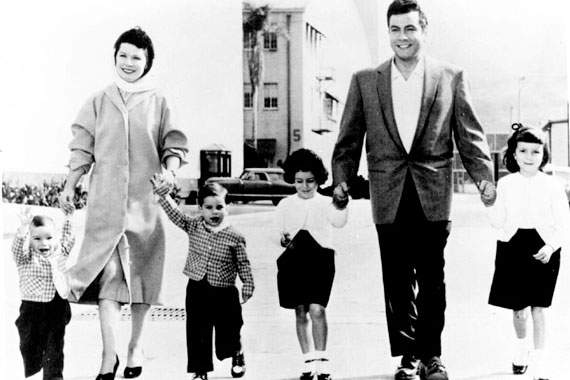 black and white picture of a family holding hands