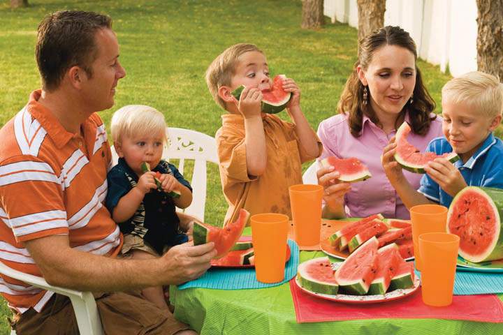 family eating watermelon