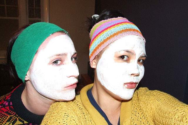 two girls with facial masks on
