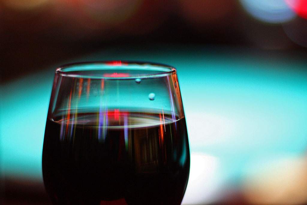red wine in a glass with a blue background